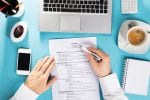 A man working on his CV - view from above his desk