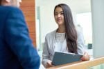 Young woman with folder discussing work related issues