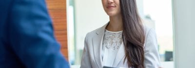 Young woman with folder discussing work related issues