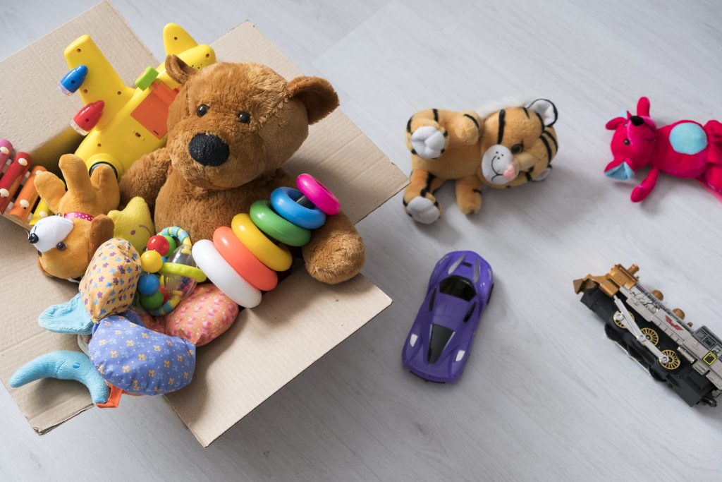 A mixture of toys in a cardboard box