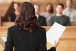 A barrister stands before a court of law giving evidence to a court of law