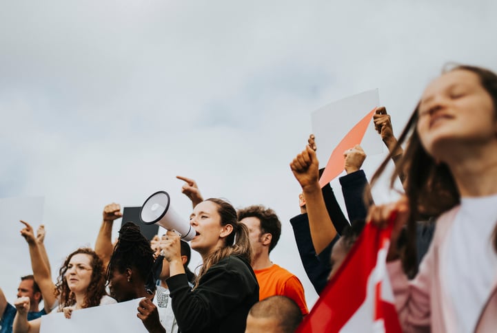 Human rights protest with women holding posters and megaphones