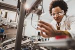 Close up of a female worker with goggles on at a factory