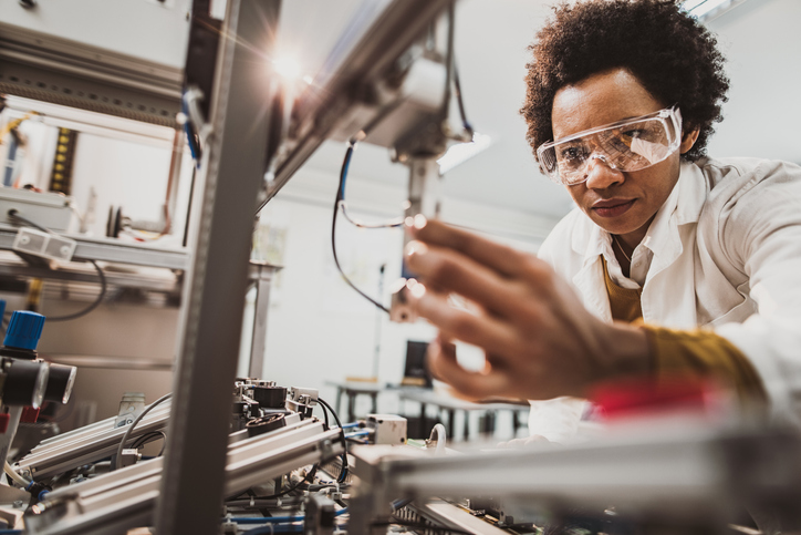 Close up of a female worker with goggles on at a factory 