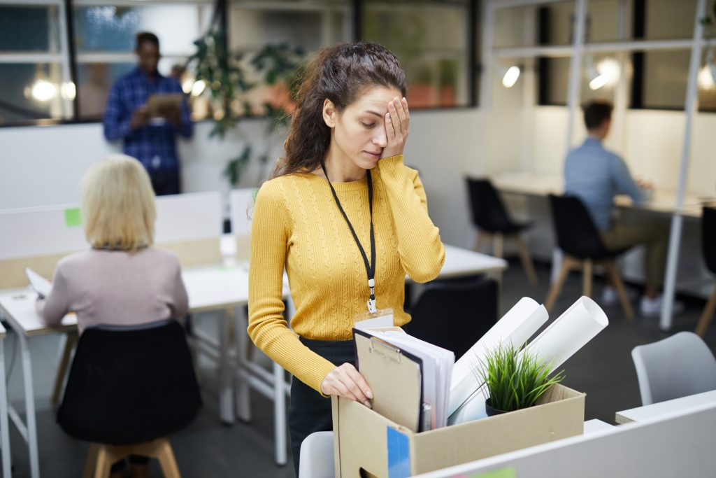 Woman being fired gathering her belongings in a box