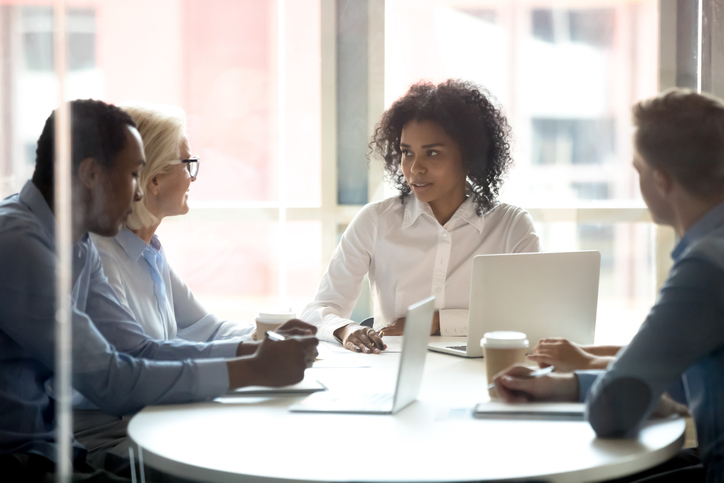 Chartered legal executive advising a client in a meeting room