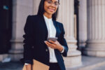 Barristers' clerk standing outsider a chambers with documents in hand