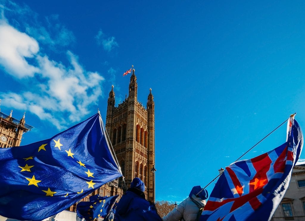 People holding EU and UK flags protesting suspension of parliament