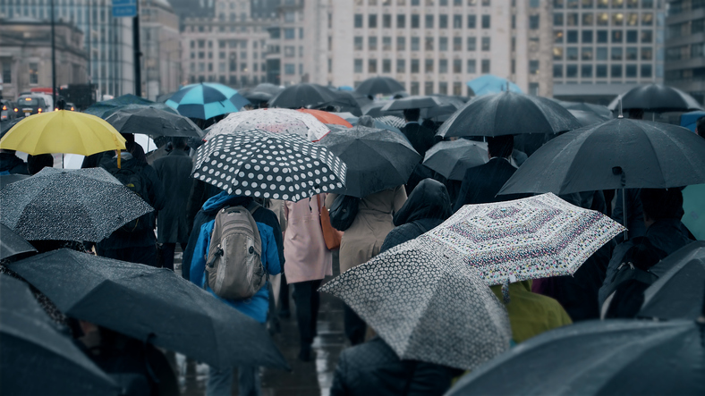 Crowd of people using umbrellas on a street during a storm