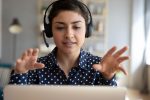 Student doing virtual work experience at her laptop with a headset on
