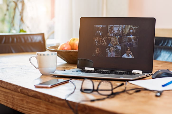 Laptop showing a zoom call with various attendees