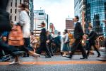 busy high street with people walking in office attire