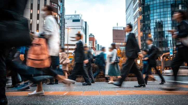 busy high street with people walking in office attire